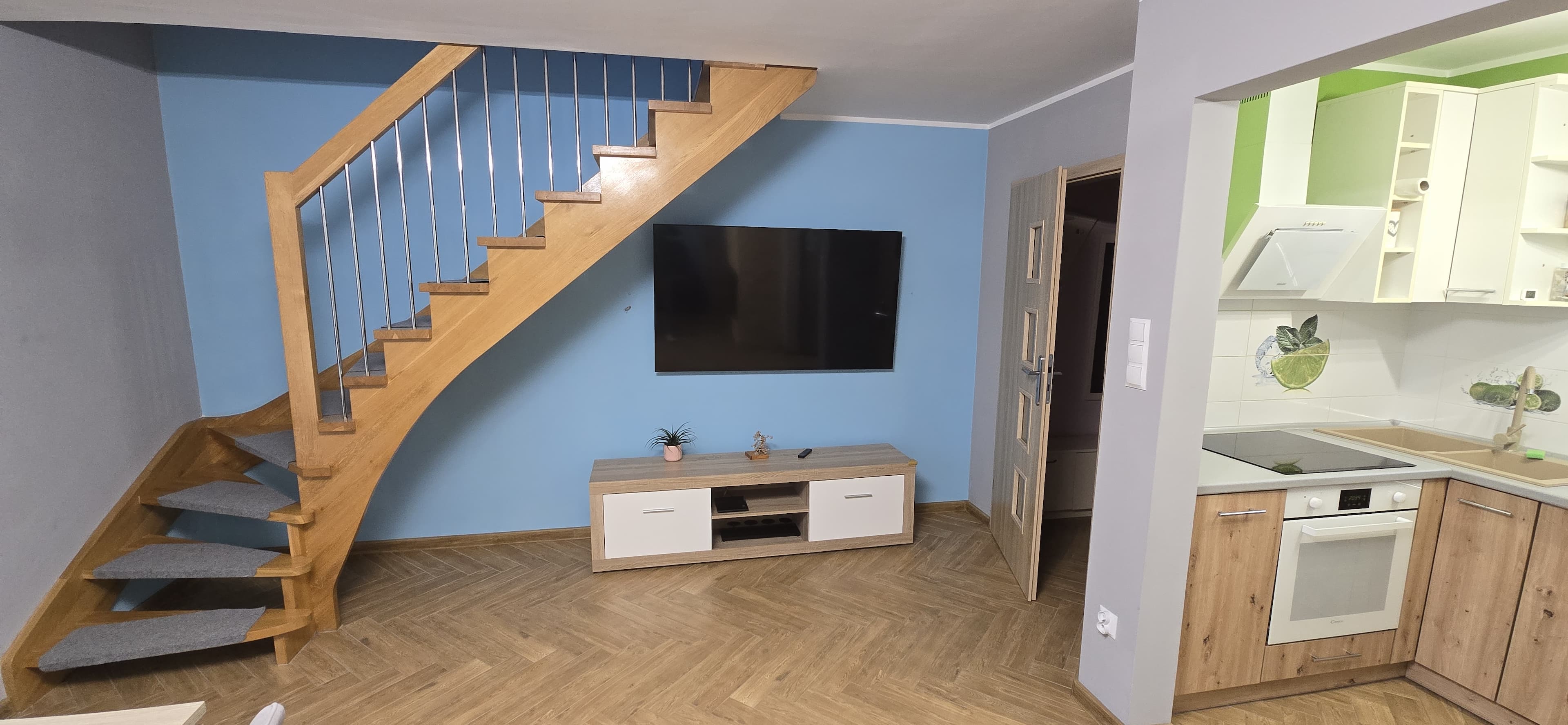 Widok na telewizor, część kuchni, schody